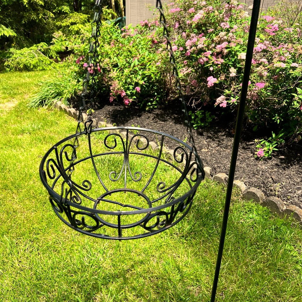 Vintage black heavy metal hanging basket outdoors